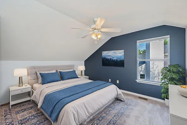 a bedroom with a bed and a chandelier