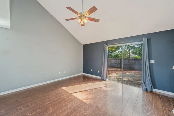 wooden floor in an empty room with a window