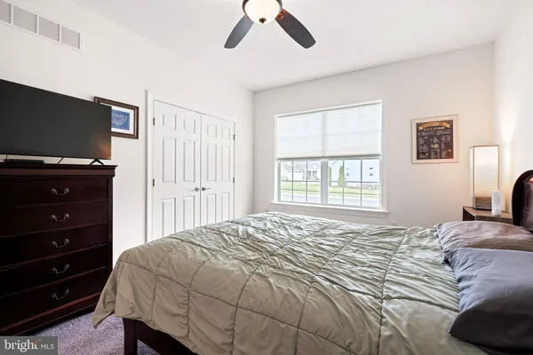 a bedroom with a bed and a flat tv screen