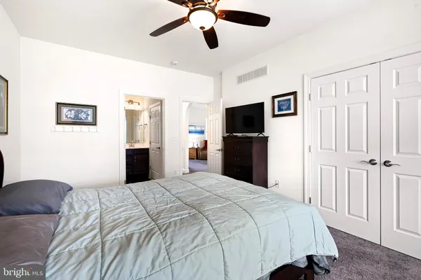 a bedroom with a bed and a flat tv screen
