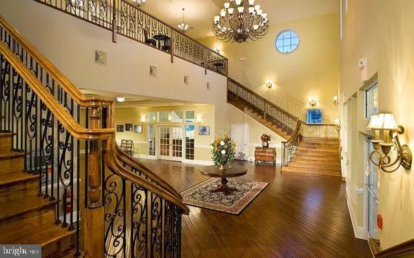 a very nice looking dining room with furniture and a chandelier