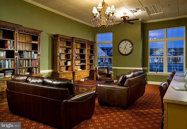 a living room with furniture a rug and a window