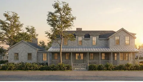 a front view of a house with plants and trees