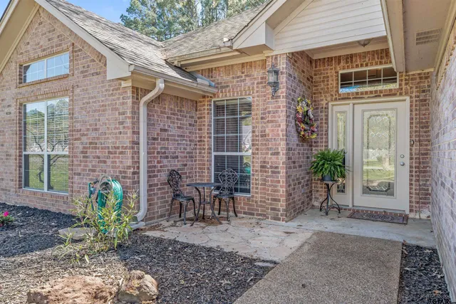 a front view of a house with outdoor seating