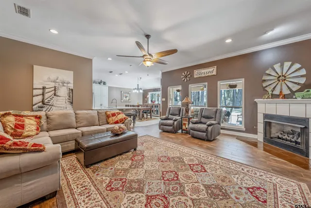 a living room with furniture a fireplace and a flat screen tv
