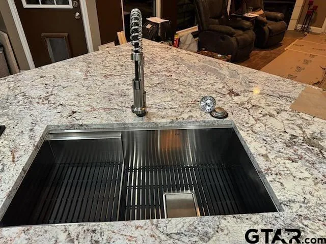 a view of a dining room with furniture a chandelier and wooden floor
