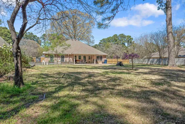 a house view with swimming pool in front of it