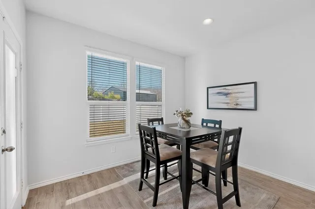 a view of a dining room with furniture and window
