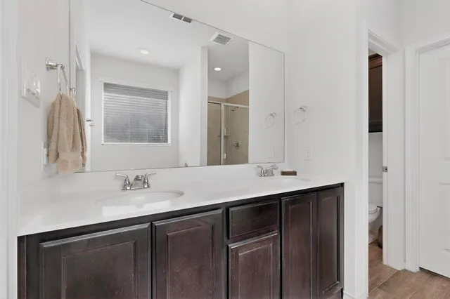 a bathroom with 2 sink and a mirror