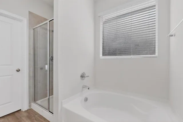 a bathroom with a bathtub and a shower