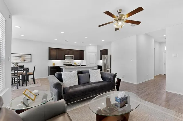 a living room with furniture and kitchen view