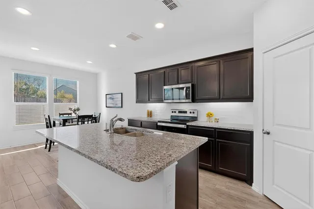 a kitchen with counter space cabinets and appliances