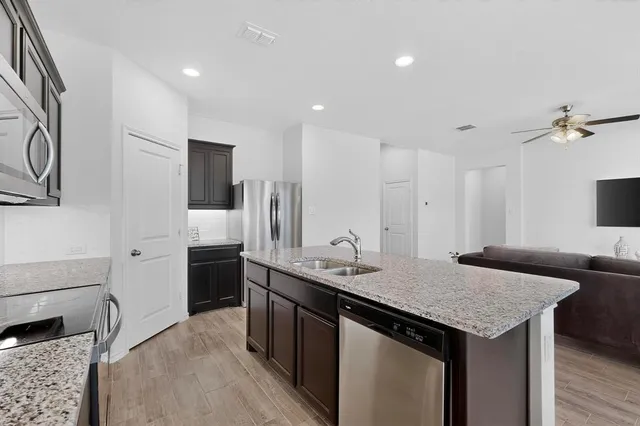 a kitchen with a stove a refrigerator and a sink