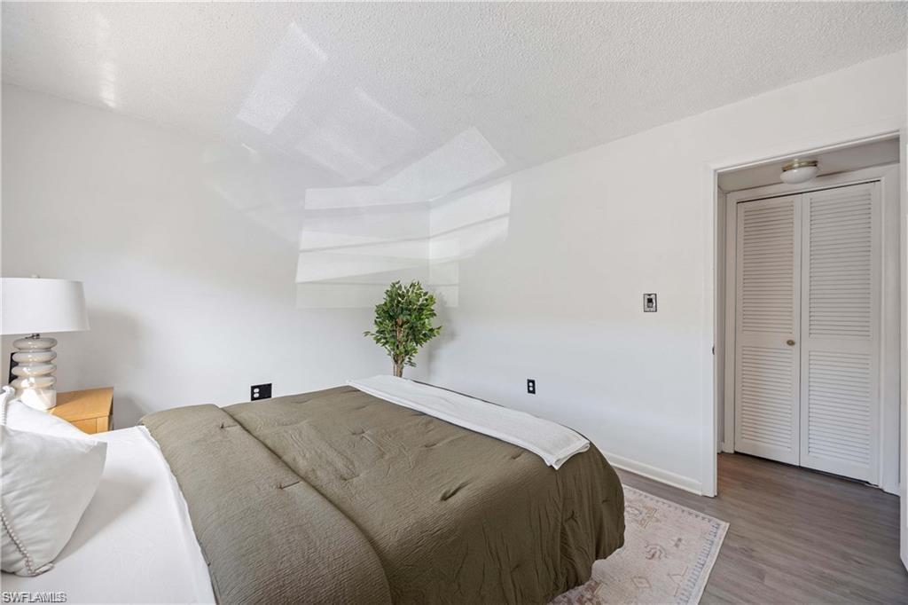 3325 Airport Road North, Unit F3 Naples, FL 34105 - Photo 10 of 15 a bedroom with a bed and a potted plant