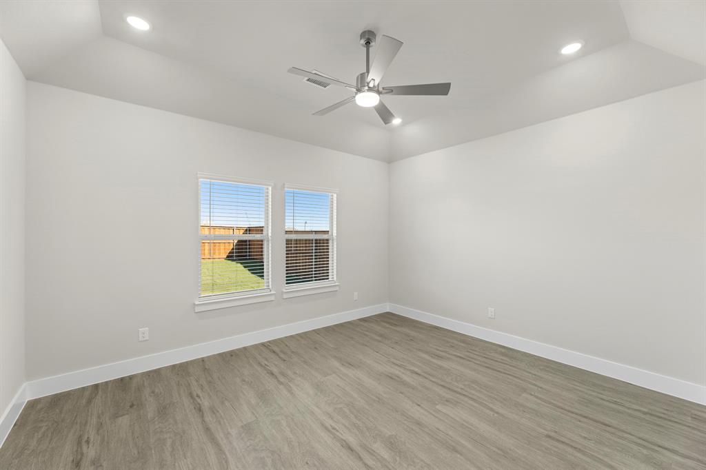 2372 Bell Way Forney, TX 75126 - Photo 29 of 39 an empty room with wooden floor fan and windows