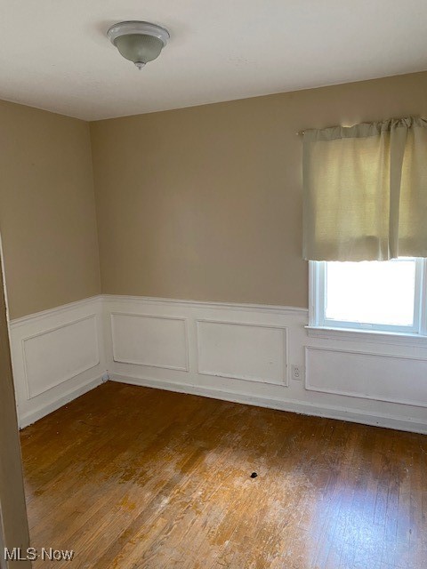 4016 Colony Road Cleveland, OH 44121 - Photo 6 of 16 Unfurnished room with hardwood / wood-style flooring