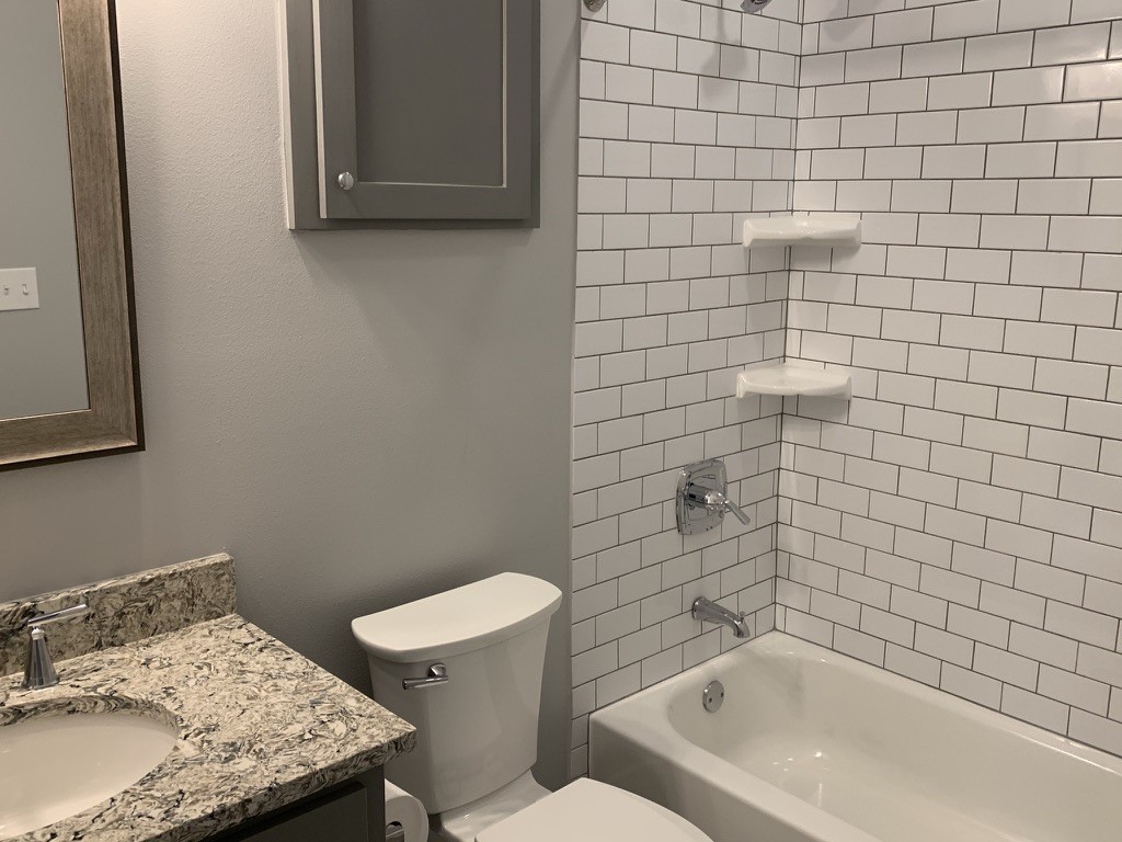 2509 South Grand Boulevard, Unit B Pearland, TX 77581 - Photo 11 of 13 a bathroom with a sink and toilet