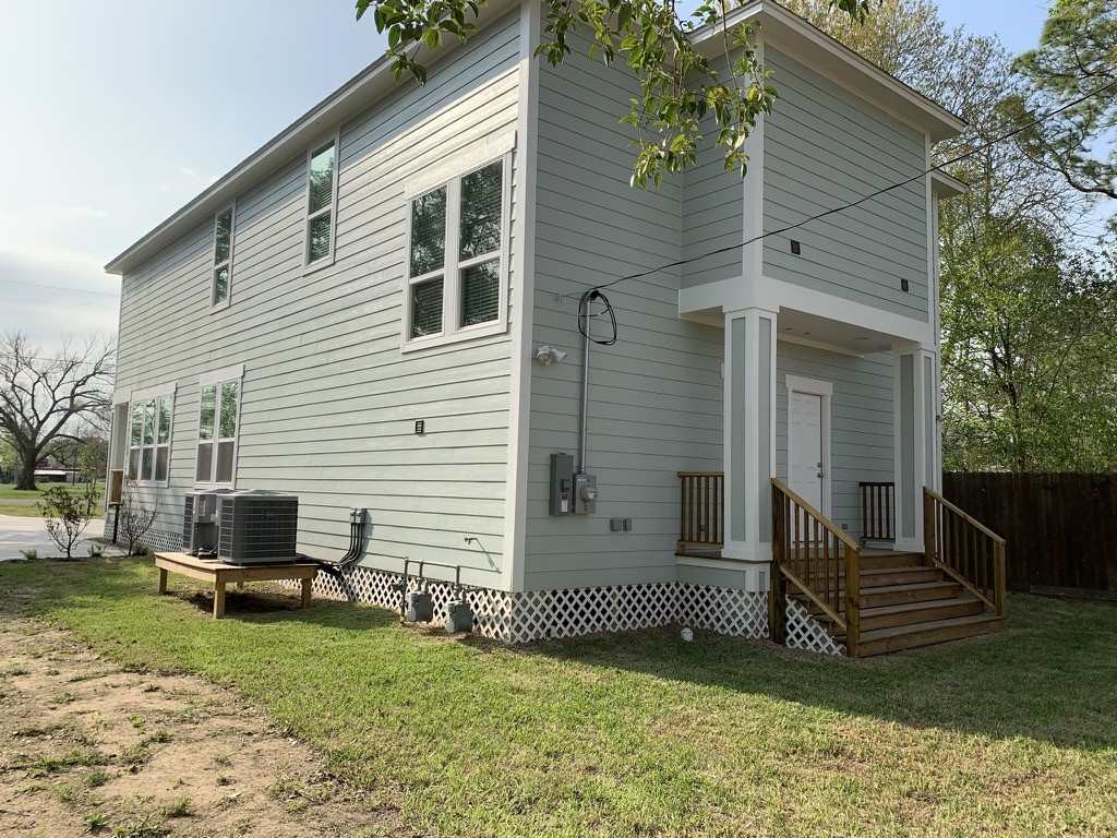 2509 South Grand Boulevard, Unit B Pearland, TX 77581 - Photo 12 of 13 a view of a house with a yard and a large tree