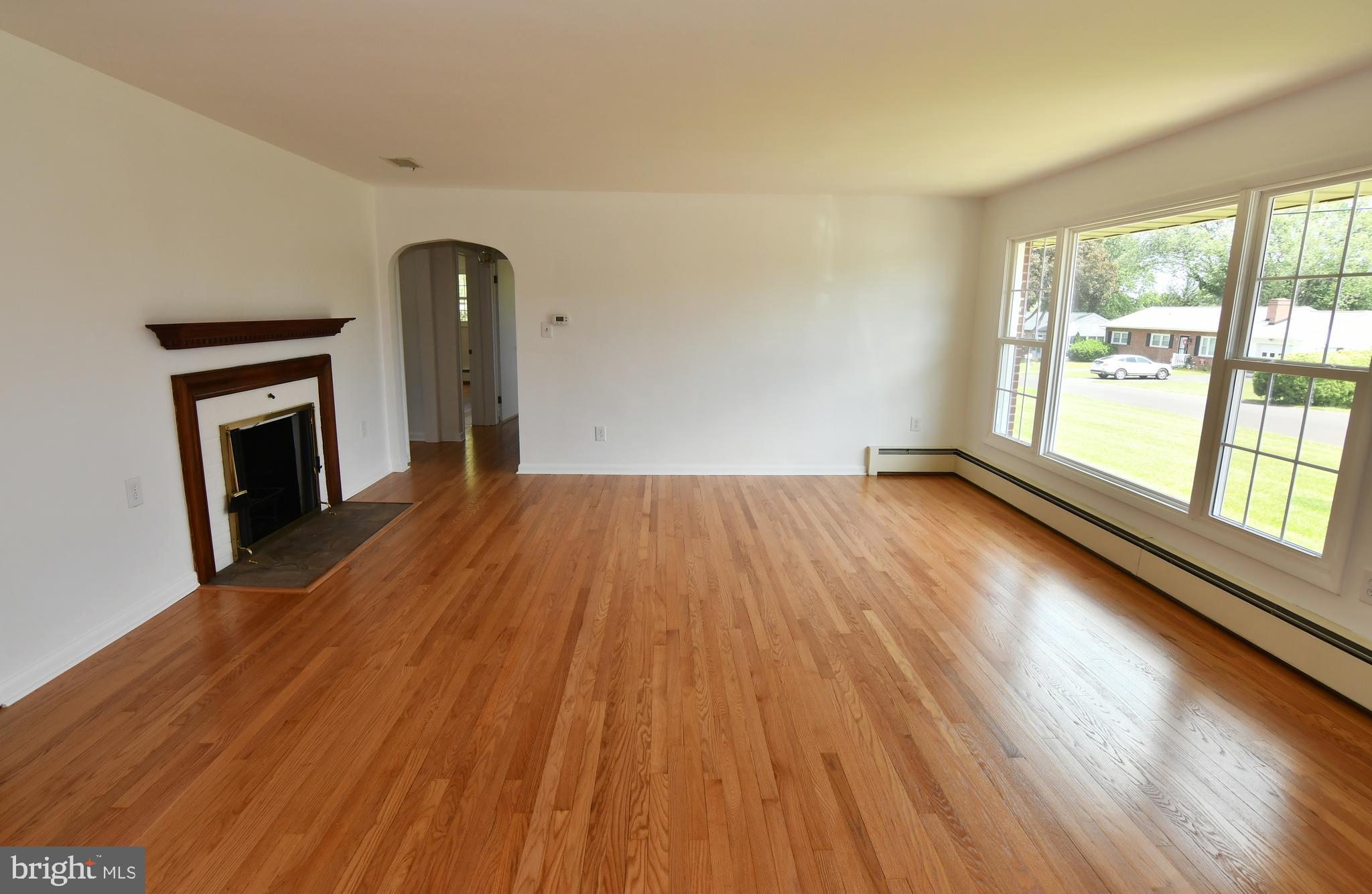 437 Beechcroft Road Winchester, VA 22601 - Photo 11 of 52 a view of empty room with wooden floor and fireplace
