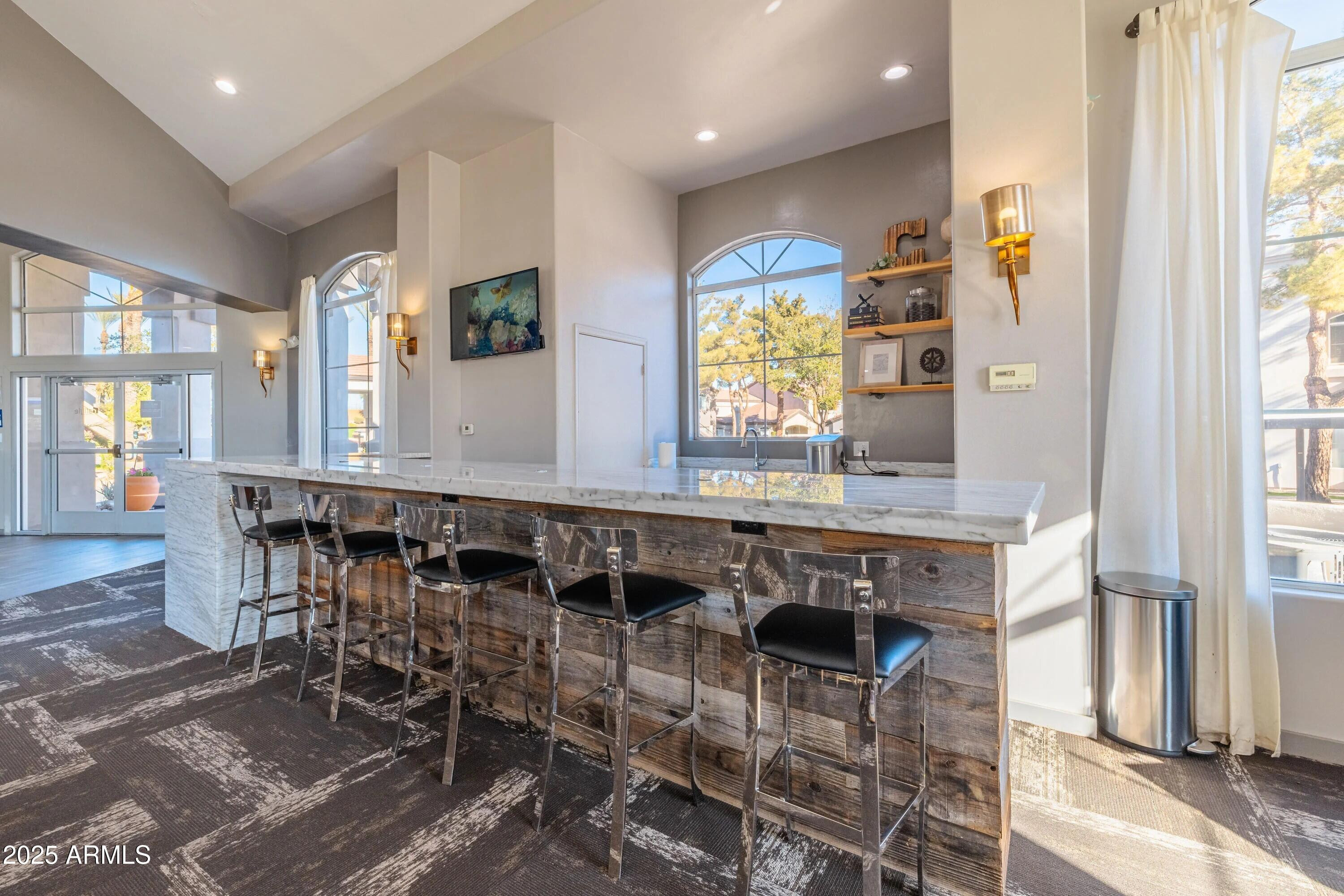 5151 East Guadalupe Road, Unit C1 Phoenix, AZ 85044 - Photo 16 of 23 a dining hall with stainless steel appliances granite countertop a table and chairs in it