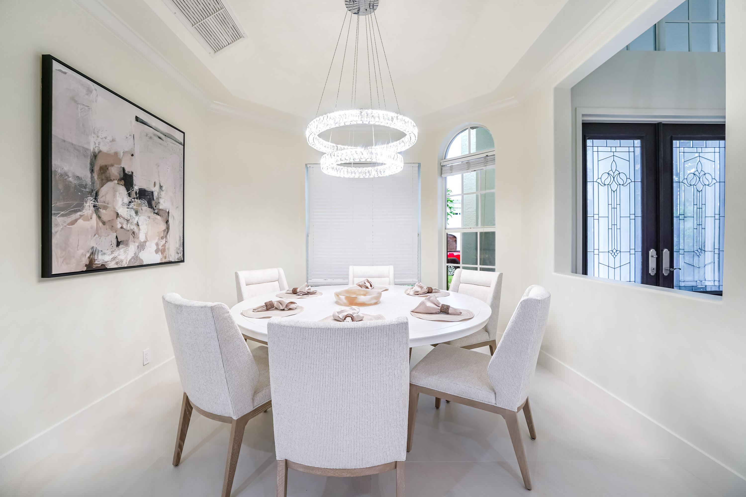 749 Northeast 71st Street Boca Raton, FL 33487 - Photo 14 of 43 a dining room with a large window table and chairs