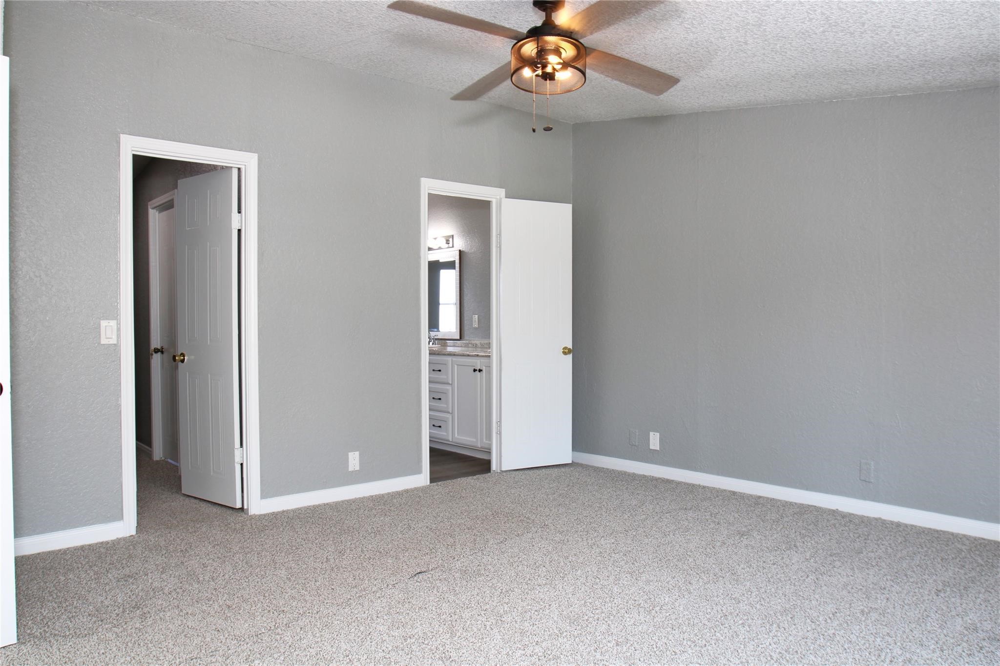 20406 Cr 510u Road Brazoria, TX 77422 - Photo 5 of 13 an empty room with a chandelier fan and wooden floor