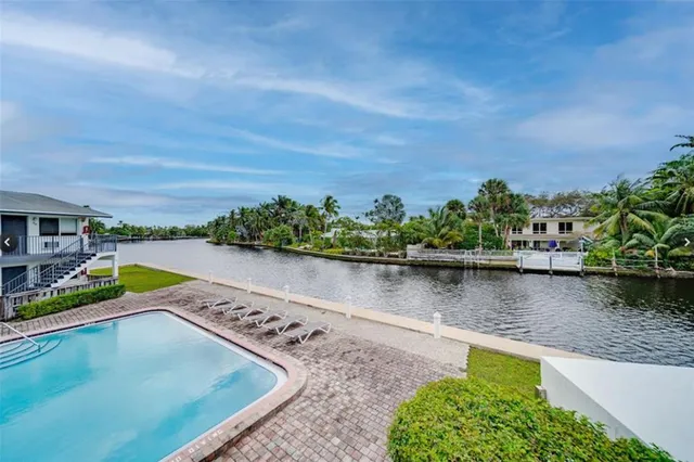 a view of a lake with houses in the back