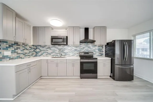 a kitchen with stainless steel appliances granite countertop a refrigerator stove a sink and dishwasher