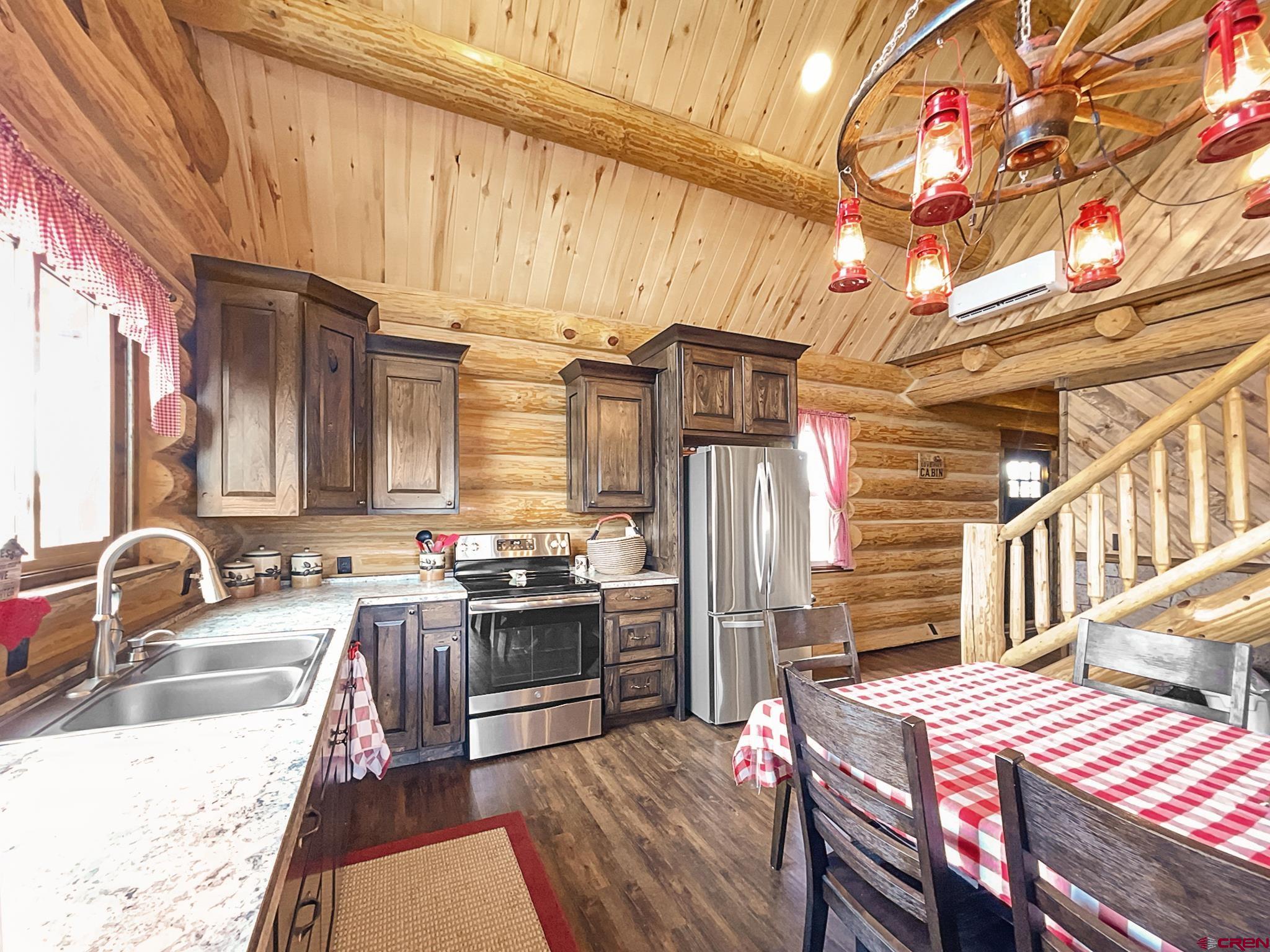 78114 Basalt Road Crawford, CO 81415 - Photo 12 of 35 a kitchen with stainless steel appliances granite countertop a sink stove and refrigerator