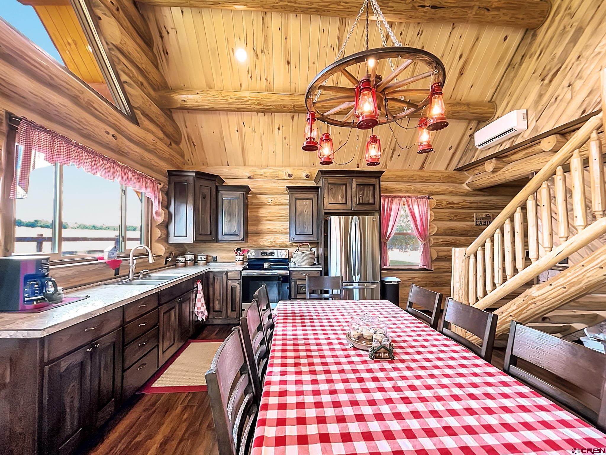 78114 Basalt Road Crawford, CO 81415 - Photo 17 of 35 a large kitchen with stainless steel appliances a stove a sink dishwasher and cabinets