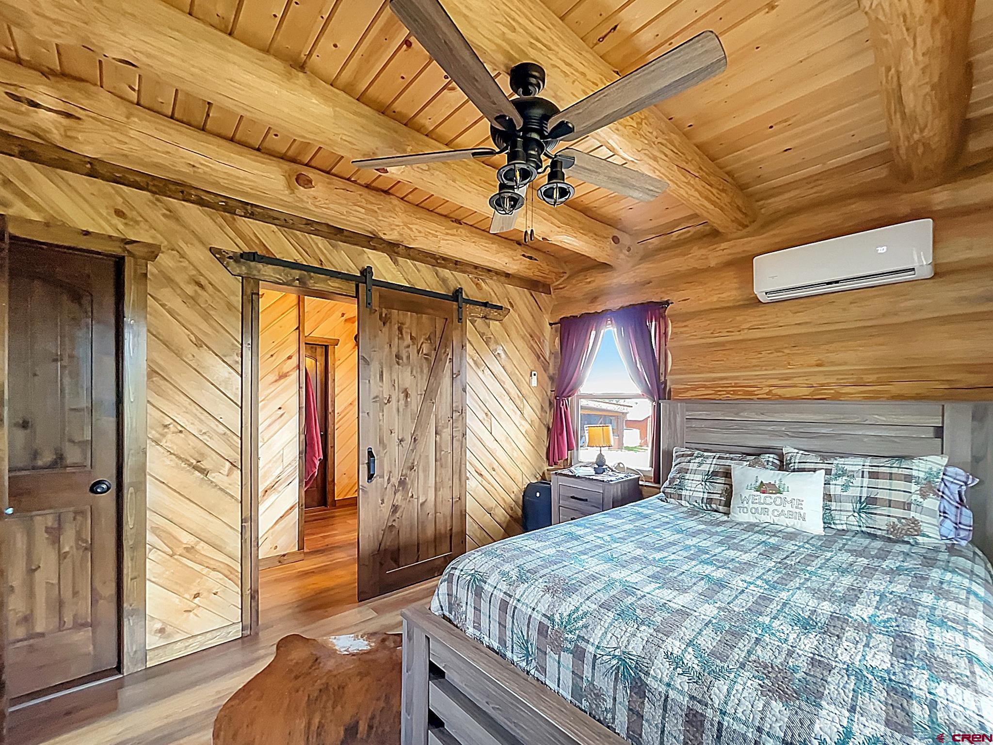 78114 Basalt Road Crawford, CO 81415 - Photo 19 of 35 a bedroom with a bed and wooden floor