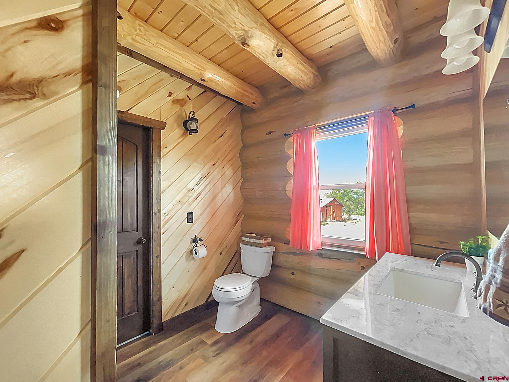 78114 Basalt Road Crawford, CO 81415 - Photo 20 of 35 a bathroom with a granite countertop sink and a large mirror