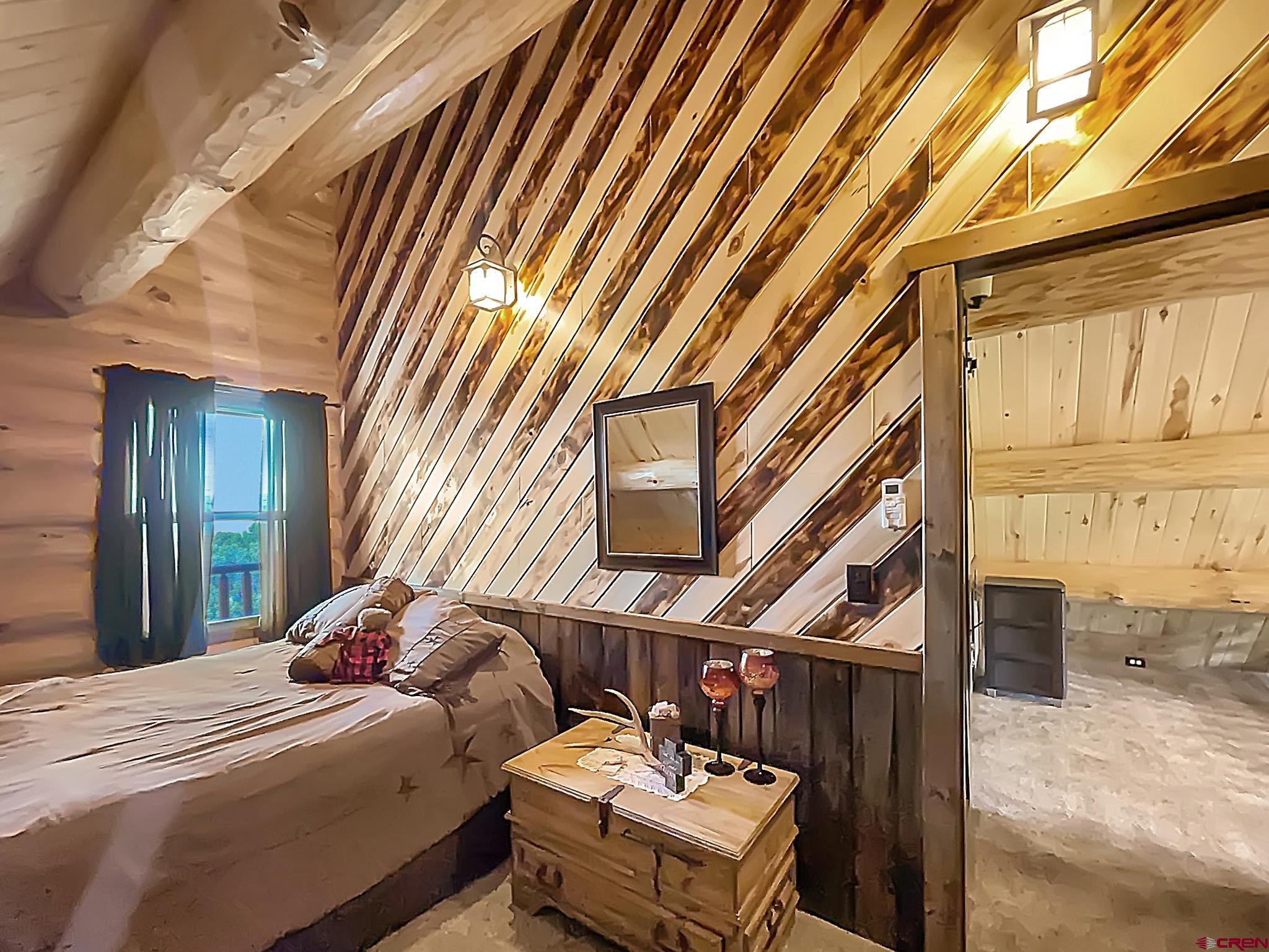 78114 Basalt Road Crawford, CO 81415 - Photo 24 of 35 a bed room with a bed and a window