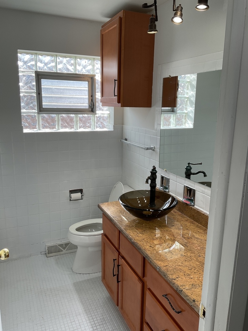 604 Exchange Avenue Calumet City, IL 60409 - Photo 6 of 39 a kitchen with a sink and a stove