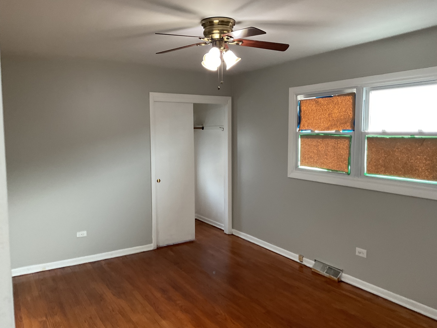 604 Exchange Avenue Calumet City, IL 60409 - Photo 8 of 39 a view of a livingroom with a window a ceiling fan and wooden floor