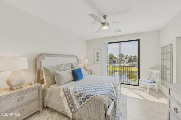a bedroom with a large bed and a chandelier