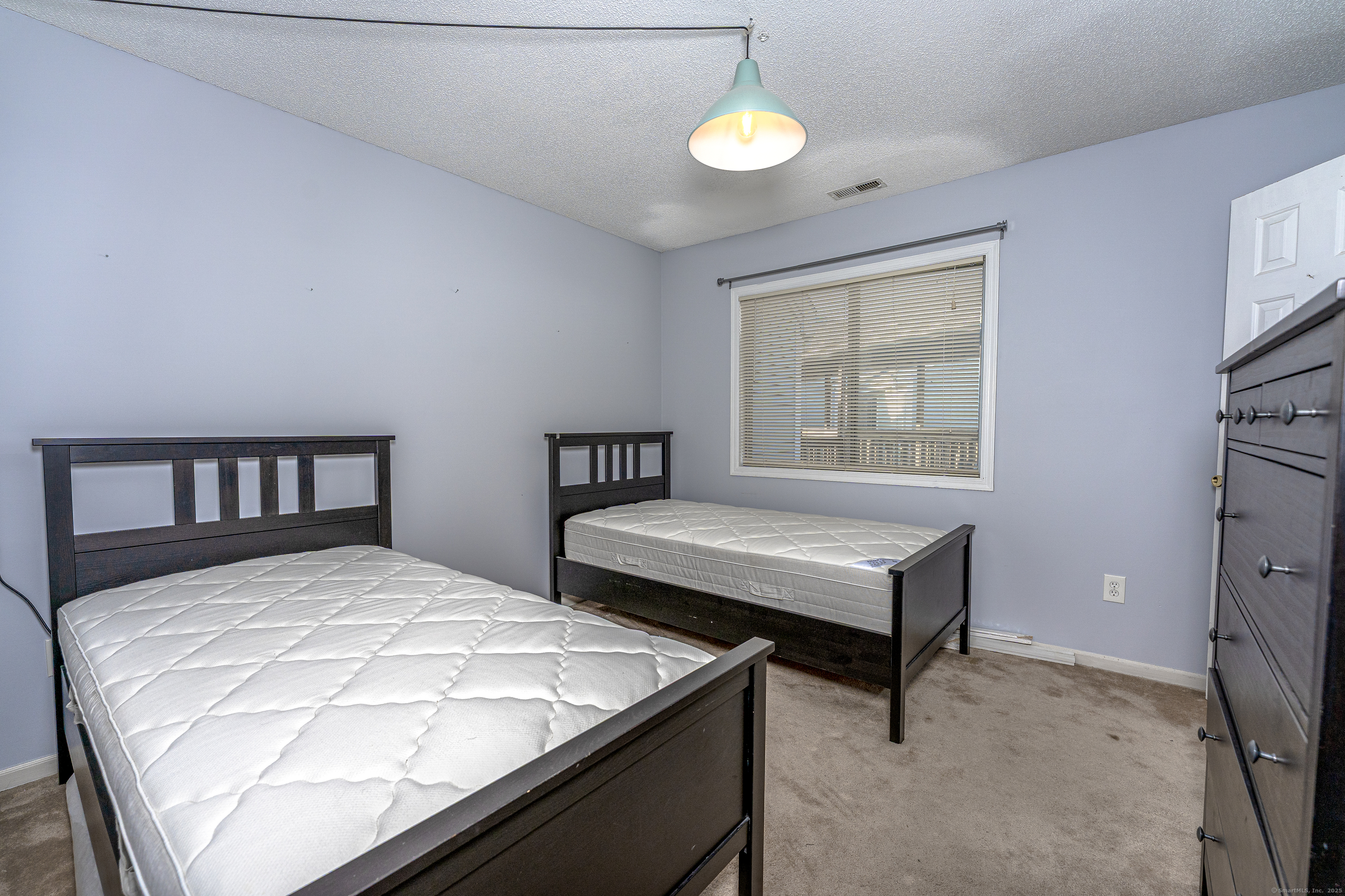 2 Mansfield Grove Road, Unit 374 East Haven, CT 06512 - Photo 13 of 30 a bedroom with two beds and a window