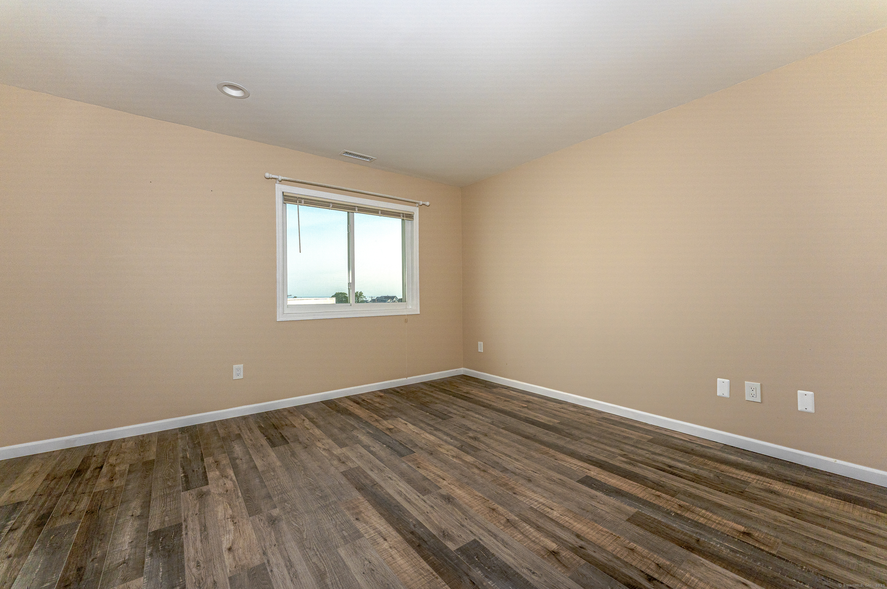 2 Mansfield Grove Road, Unit 374 East Haven, CT 06512 - Photo 20 of 30 a view of an empty room with wooden floor and a window