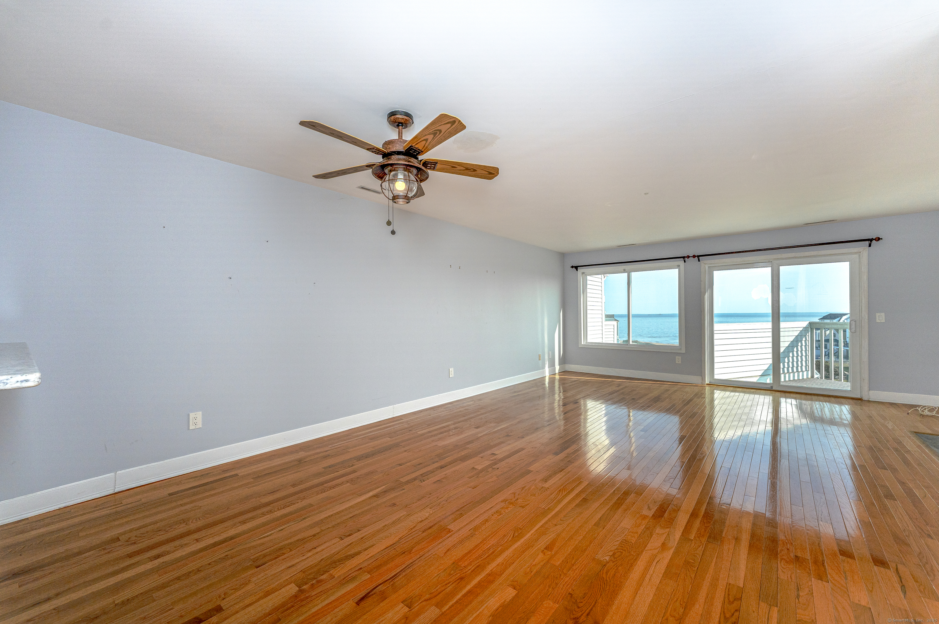 2 Mansfield Grove Road, Unit 374 East Haven, CT 06512 - Photo 4 of 30 a view of empty room with wooden floor and fan