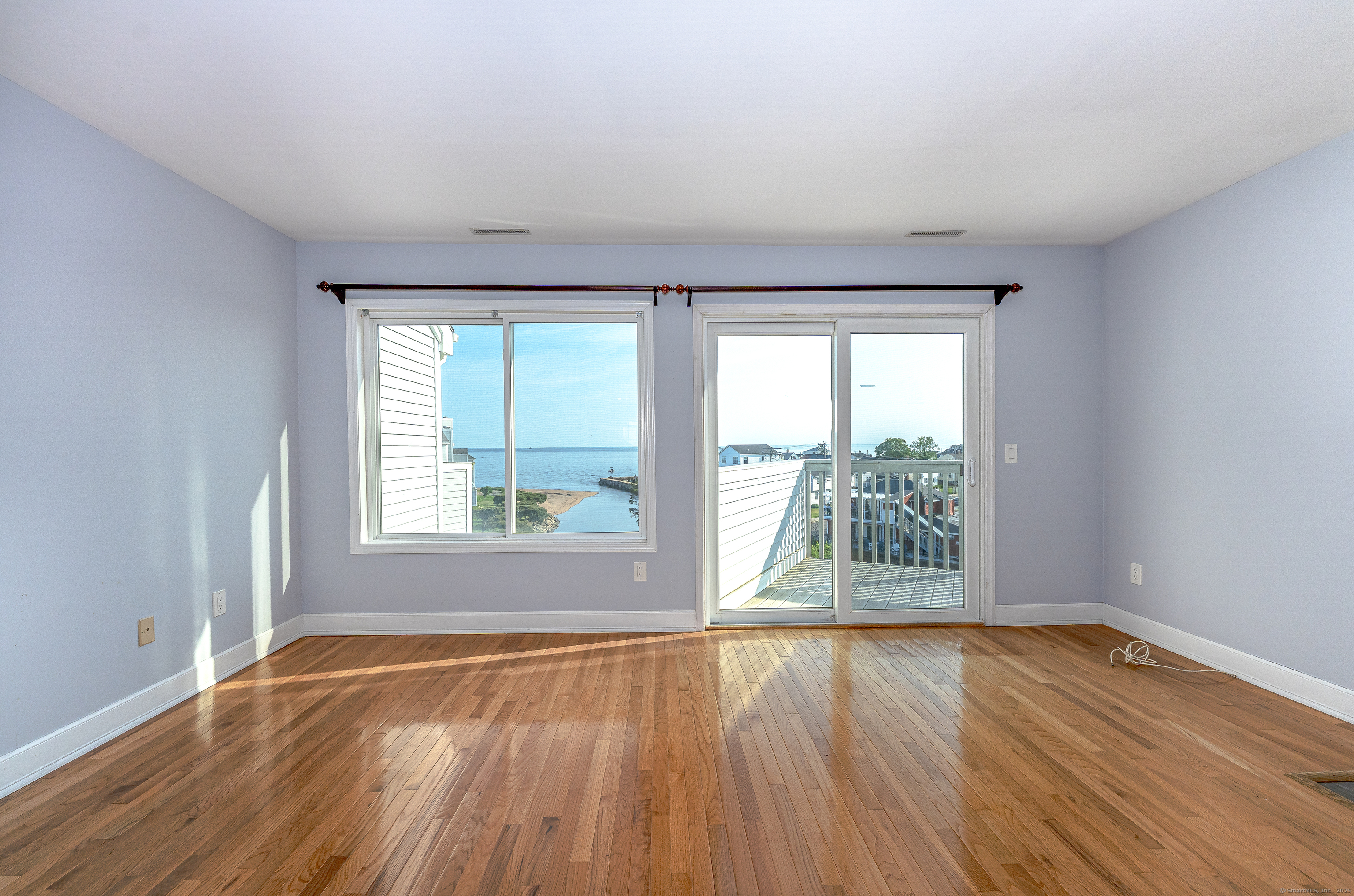 2 Mansfield Grove Road, Unit 374 East Haven, CT 06512 - Photo 5 of 30 a view of an empty room with wooden floor and a window