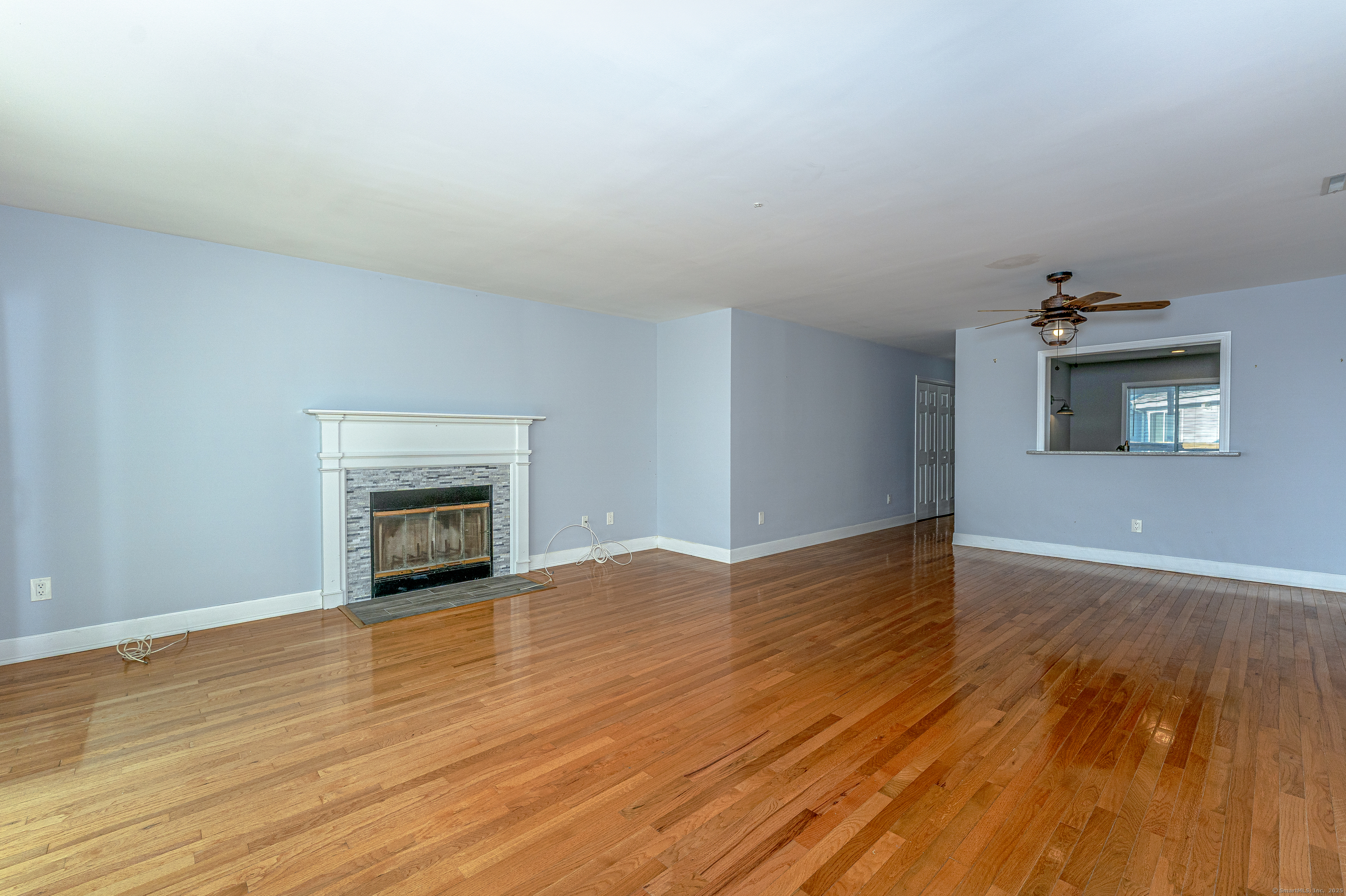 2 Mansfield Grove Road, Unit 374 East Haven, CT 06512 - Photo 6 of 30 a view of an empty room with wooden floor and a window