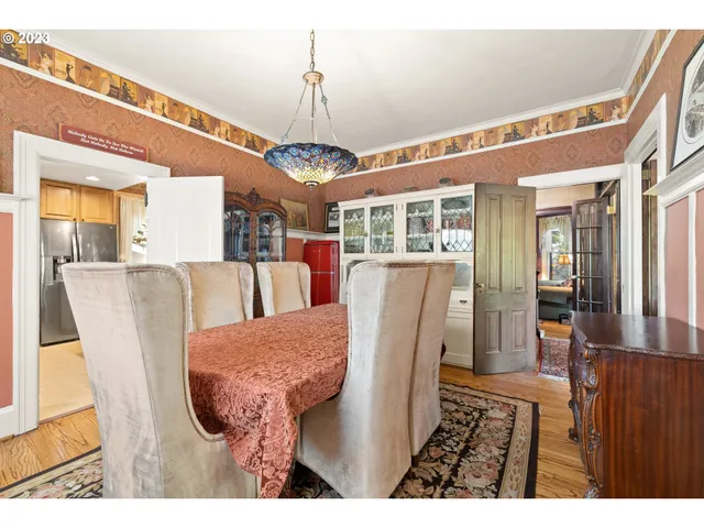 a view of a dining room with furniture wooden floor and chandelier