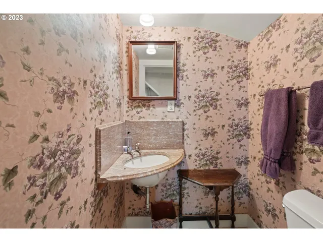 a bathroom with a sink a toilet and mirror