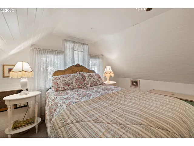 a bedroom with a bed and a night stand