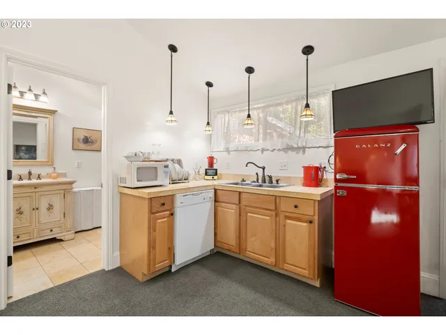 a kitchen with white cabinets and white appliances