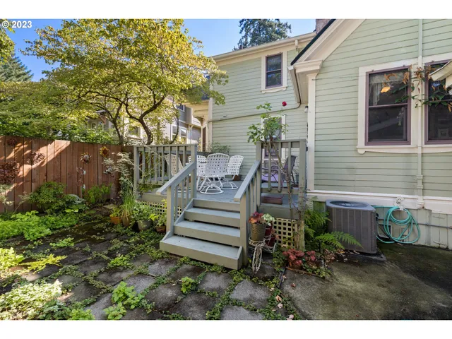 a view of a house with backyard and wooden fence