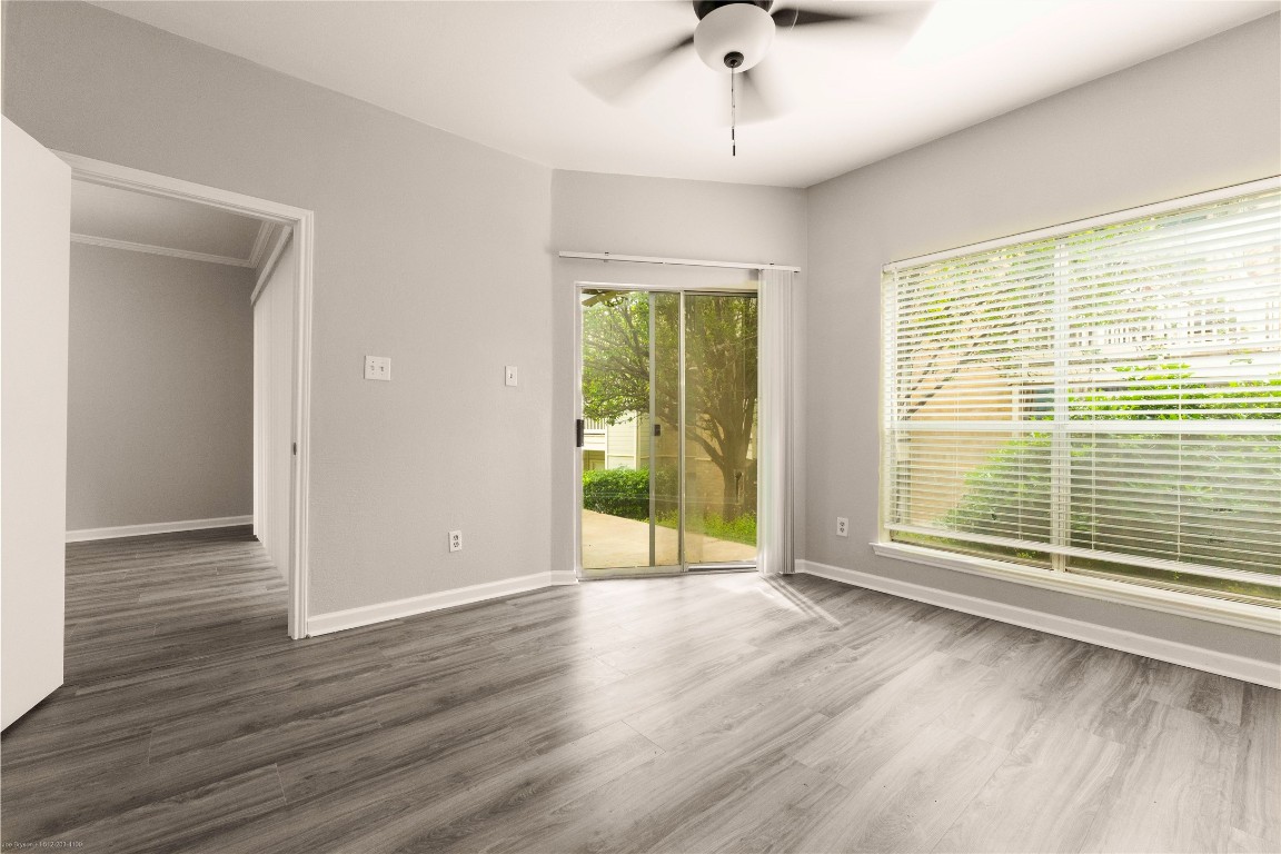 2450 Wickersham Lane, Unit 1001 Austin, TX 78741 - Photo 13 of 18 a view of an empty room with wooden floor and a window