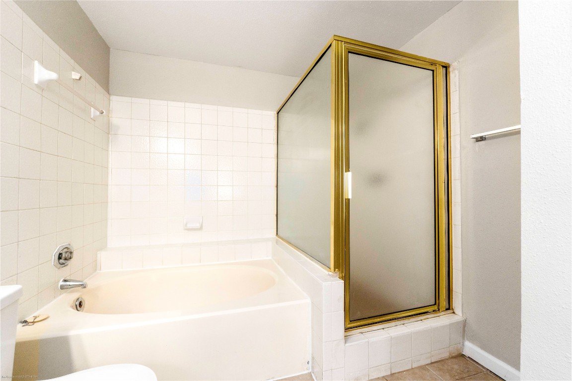 2450 Wickersham Lane, Unit 1001 Austin, TX 78741 - Photo 15 of 18 a bathroom with a bathtub and a shower