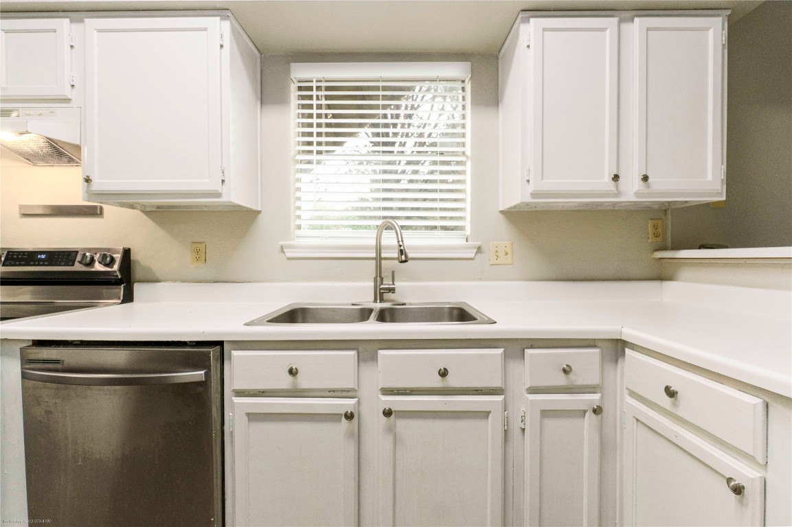 2450 Wickersham Lane, Unit 1001 Austin, TX 78741 - Photo 6 of 18 a kitchen with a sink cabinets and window