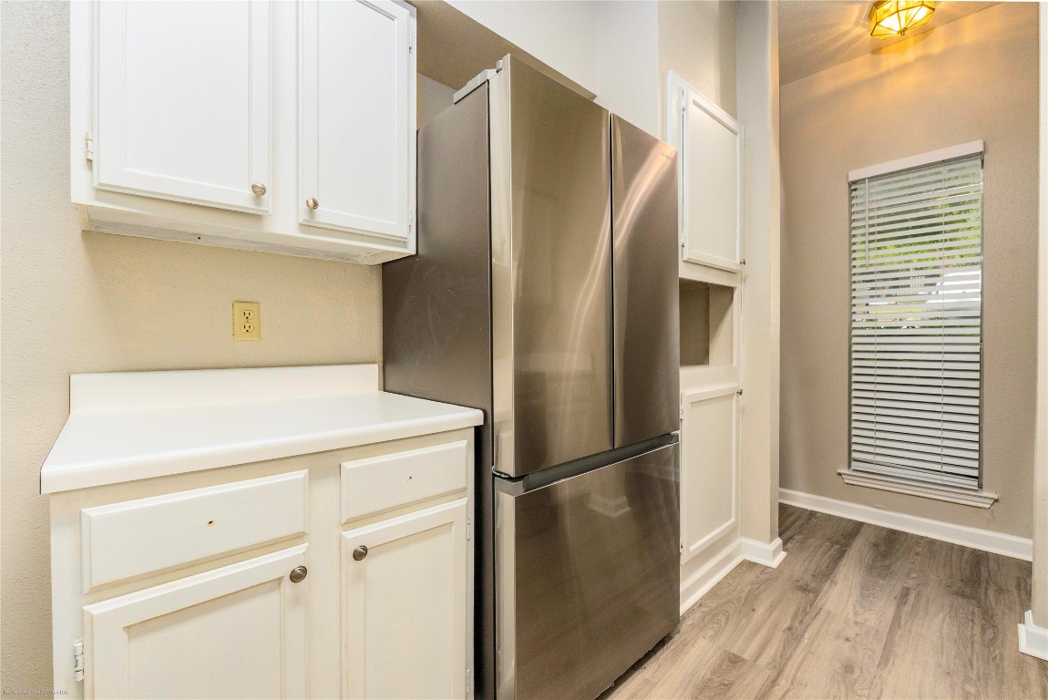 2450 Wickersham Lane, Unit 1001 Austin, TX 78741 - Photo 7 of 18 a view of a refrigerator in kitchen and an empty room